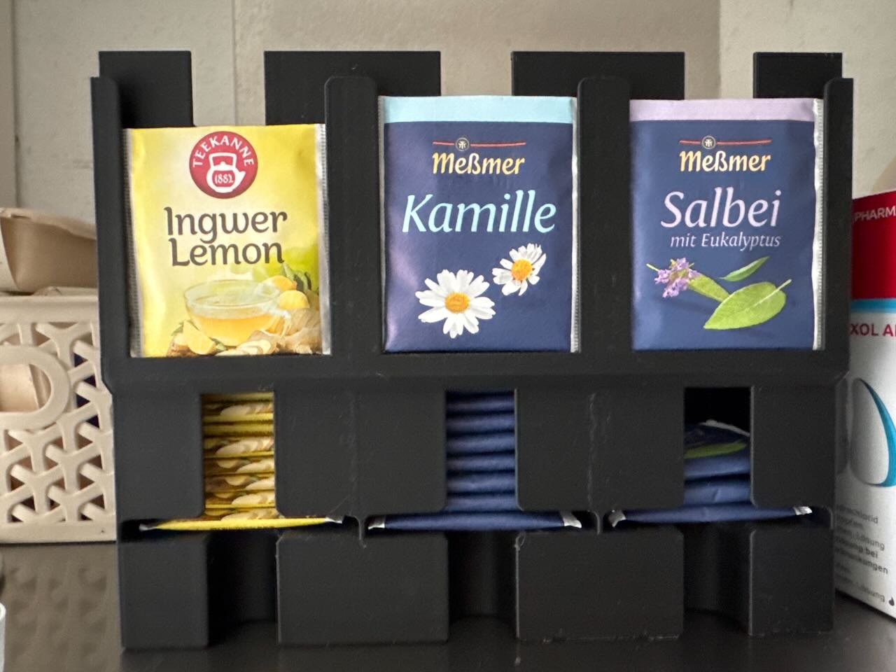 A picture of a 3D-printed tea dispenser with convenience slots for displaying a tea sample